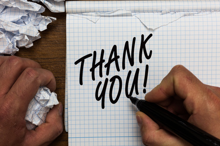 Text sign showing Thank You. Conceptual photo replaying on something good or greetings with pleased way Man holding marker notebook crumpled papers ripped pages mistakes madeの写真素材
