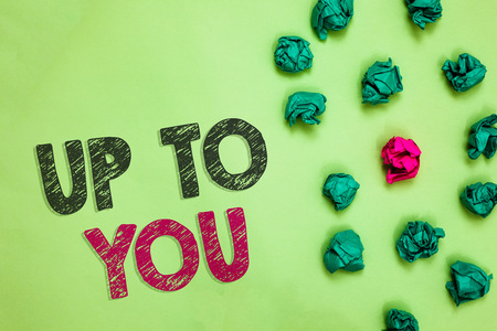 Text sign showing Up To You. Conceptual photo A person giving freedom to choose or decide on something Crumpled wrinkled papers one different pink unique special green backgroundの写真素材