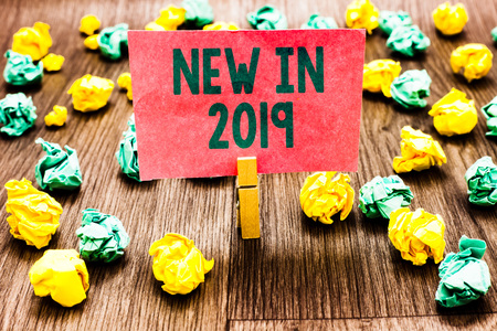Word writing text New In 2019. Business concept for list of fresh things got introduced this year or the next Clothespin holding pink note paper crumpled papers several tries mistakesの写真素材