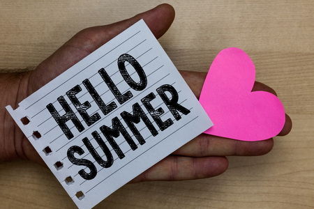 Text sign showing Hello Summer. Conceptual photo Welcoming the warmest season of the year comes after spring Man holding piece notebook paper heart Romantic ideas messages feelingsの写真素材