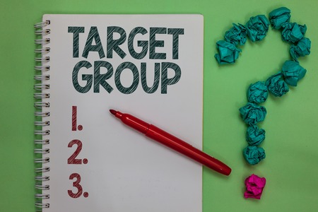 Handwriting text Target Group. Concept meaning Particular people that an advertisement intended to reach to Notebook marker crumpled papers forming question mark green backgroundの写真素材