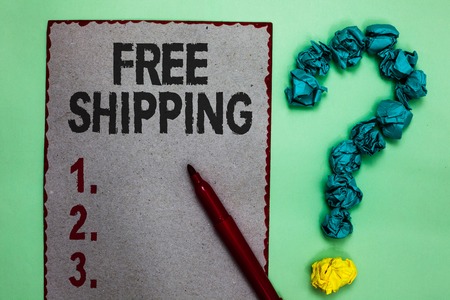 Handwriting text writing Free Shipping. Concept meaning Freight Cargo Consignment Lading Payload Dispatch Cartage Gray paper marker crumpled papers forming question mark green backgroundの写真素材