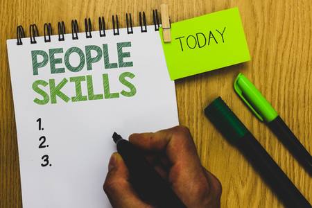 Word writing text People Skills. Business concept for Get Along well Effective Communication Rapport Approachable Man holding marker notebook clothespin reminder wooden table cup coffeeの写真素材