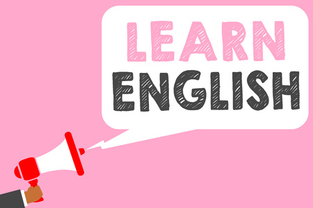 Text sign showing Learn English. Conceptual photo Universal Language Easy Communication and Understand Man holding megaphone loudspeaker speech bubble message speaking loudの写真素材