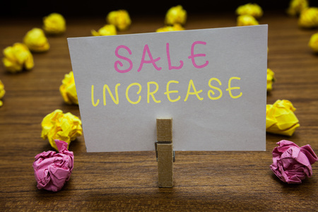Handwriting text writing Sale Increase. Concept meaning Average Sales Volume has Grown Boost Income from Leads Clothespin holding white paper note crumpled papers several tries mistakesの写真素材