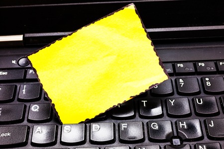 Design business concept Empty copy text for Web banners promotional material mock up template. Blank Painted Notepad Reminding Inserted Between Keys of Laptop Keyboardの写真素材