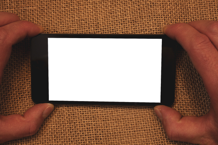 Business Empty template for Layout for invitation greeting card promotion poster voucher. Man holding cell phone white screen message application wicker backgroundの写真素材