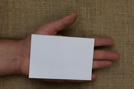 Design business Empty template isolated Minimalist graphic layout template for advertising . Huanalysis hand holding white page with black and red color texts on sackの写真素材