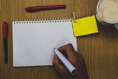 Design business Empty template isolated Minimalist graphic layout template for advertising . Man holding marker notebook wooden table for today important coffee cupの写真素材