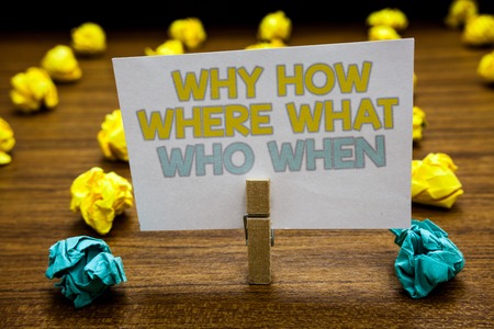 Writing note showing Why How Where What Who When. Business photo showcasing Questions to find solutions Query Asking Written notepad stand with paperclip yellow blue lobs on wooden deckの写真素材