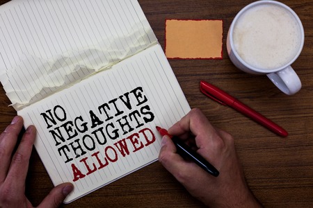 Handwriting text writing No Negative Thoughts Allowed. Concept meaning Always positive motivated inspired good vibes Sticky note red pen coffee with coffee mug hand hold pen with written wordsの写真素材