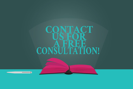 Handwriting text writing Contact Us For A Free Consultation. Concept meaning We are available for giving support Color Pages of Open Book photo on Table with Pen and Light Beam Glaringの写真素材