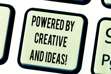 Text sign showing Powered By Creative And Ideas. Conceptual photo Powerful creativity innovation good energy Keyboard key Intention to create computer message pressing keypad ideaの写真素材
