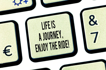 Conceptual hand writing showing Life Is A Journey Enjoy The Ride. Business photo text Enjoying things that happen everyday Keyboard key Intention to create computer message ideaの写真素材