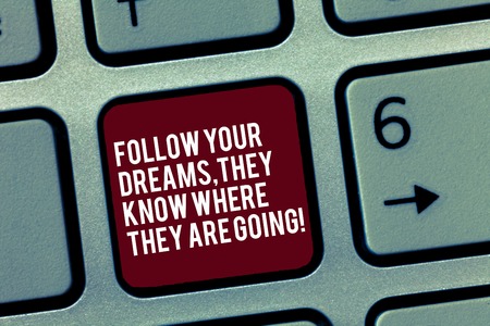 Text sign showing Follow Your Dreams They Know Where They Are Going. Conceptual photo Accomplish goals Keyboard key Intention to create computer message, pressing keypad ideaの写真素材
