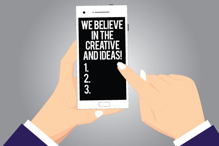 Handwriting text writing We Believe In The Creative And Ideas. Concept meaning Have faith in creativity innovation Hu analysis Hands Holding Pointing Touching Smartphone Blank Color Screenの写真素材