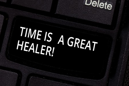 Handwriting text Time Is A Great Healer. Concept meaning Emotional pain will grow less after a while Keyboard key Intention to create computer message pressing keypad ideaの写真素材