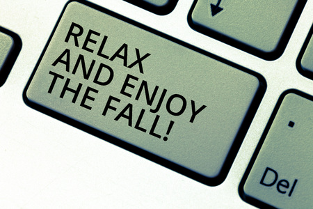 Writing note showing Relax And Enjoy The Fall. Business photo showcasing Enjoying the autumn season beautiful falling leaves Keyboard key Intention to create computer message pressing keypad ideaの写真素材