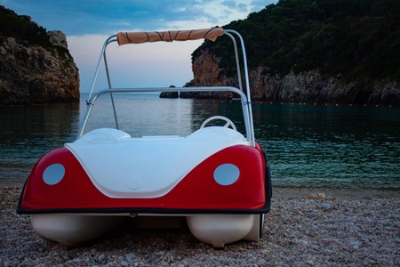 Boat trip along river in Corfu Greece. Ship on clean blue water. Island houses on the shore view. Greek beautiful landscape. White boats sailing. Relaxation, travelingの写真素材