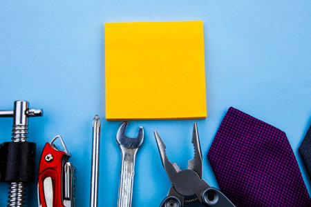 Empty yellow paper with blue background and tools. Tools background concept with copy space on the...