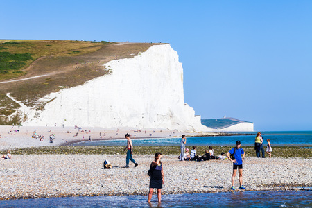Brighton, UK - June 2018 People Relaxing on the Pebbled Shore Coastline of the White Chalk Beach. Famous Elevated Ground for Countryside destination ideas at Seven Sisters Cliffのeditorial素材