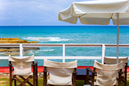 Sunny day on the beach with umbrellas and seats. Blue sky at the beautiful weather. Holiday concept...