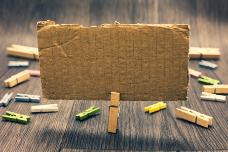 Business concept Empty template copy space isolated Posters coupons promotional material. Clothespin holding paperboard important communicating message ideasの写真素材