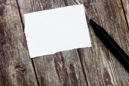 Design business concept Empty copy text for Web banners promotional material mock up template. Blank Torn Edges Graph Paper Uncapped Marker for Writing on Wooden Surfaceの写真素材