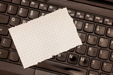 Design business Empty copy space text for Ad website promotion isolated Banner template. Blank Torn Edges Graph Paper for Plotting Lying on Laptop Keyboardの写真素材