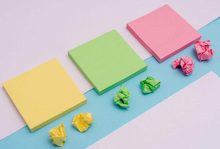 Note papers and stationary placed sideways on top of softhued backdrop Copy Space design Empty...