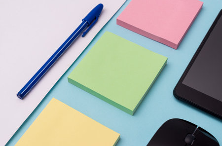 Note papers and stationary plus gadgets placed sideways above backdrop Design business Empty...