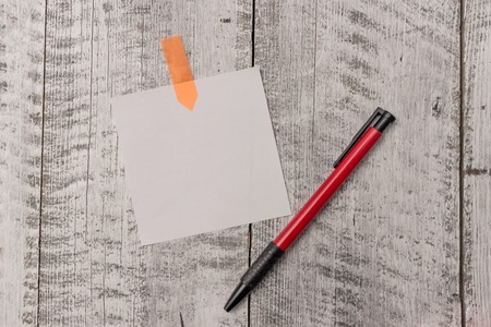 One plain blank paper sheet and a pen attached with wooden textured table Design business concept Empty copy space modern abstract backgroundの写真素材