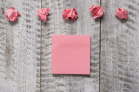 Thick set of plain note paper with scraps on the wooden textured table Design business concept Empty...