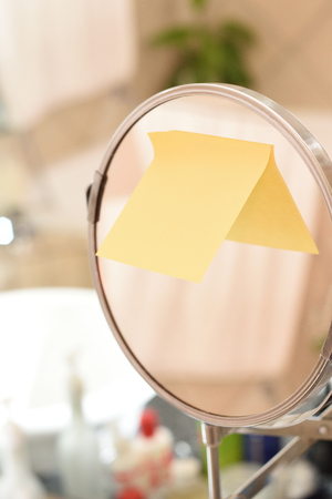 Round shape mirror and toiletries placed next to sink in a modern bathroomの写真素材