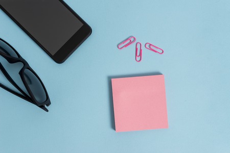 Eyeglasses colored sticky note smartphone clips fashion pastel backgroundの写真素材