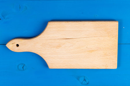 Colored Background front view wooden solid chopping board. Home utensils