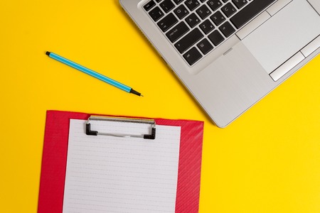 Trendy metallic laptop clipboard paper sheet marker colored backgroundの写真素材