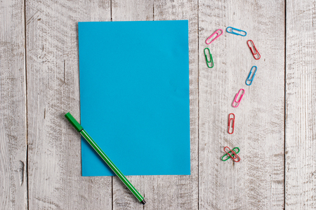 Pastel colour note paper placed next to stationary above the wooden tableの写真素材