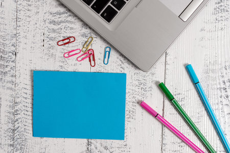 Trendy metallic laptop blank sticky note colored clips pens lying vintageの写真素材
