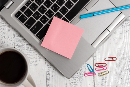 Trendy metallic laptop blank sticky pad coffee cup clips pen vintage tableの写真素材