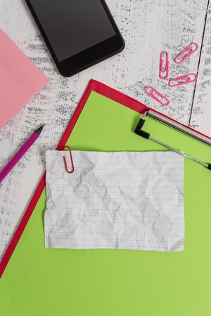 Clipboard sheet pencil smartphone note clips notepad wooden backgroundの写真素材