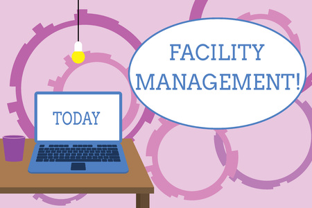 Word writing text Facility Management. Business photo showcasing Multiple Function Discipline Environmental Maintenance Front view open laptop lying on wooden desktop light bulb falling glassの写真素材