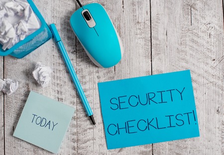 Conceptual hand writing showing Security Checklist. Concept meaning Protection of Data and System Guide on Internet Theft Crumpled paper in bin and computer mouse on wooden backdrop.の写真素材