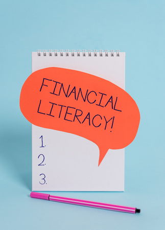 Handwriting text writing Financial Literacy. Conceptual photo Understand and knowledgeable on how money works Standing blank spiral notepad speech bubble pen lying cool backgroundの写真素材