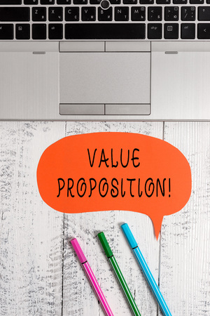 Handwriting text writing Value Proposition. Conceptual photo service make company or product attractive to customers Open laptop blank speech bubble pens ballpoints lying vintage wooden tableの写真素材