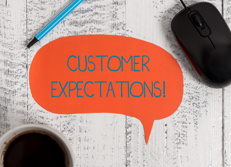 Writing note showing Customer Expectations. Business concept for Benefits a Client Expect Surpass the needs and wants Wooden vintage table background coffee cup speech bubbleの写真素材