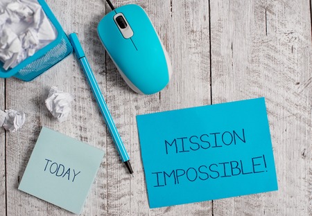 Conceptual hand writing showing Mission Impossible. Concept meaning Difficult Dangerous Assignment Isolated Unimaginable Task Crumpled paper in bin and computer mouse on wooden backdrop.の写真素材