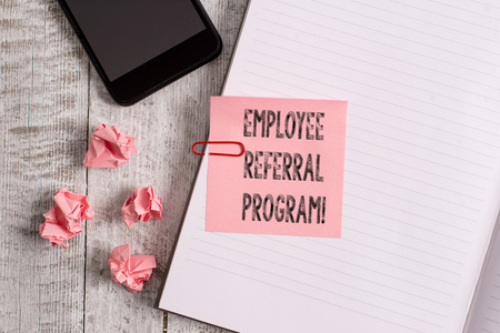 Conceptual hand writing showing Employee Referral Program. Concept meaning internal recruitment method employed by organizations Notebook stationary placed above classic wooden backdropの写真素材