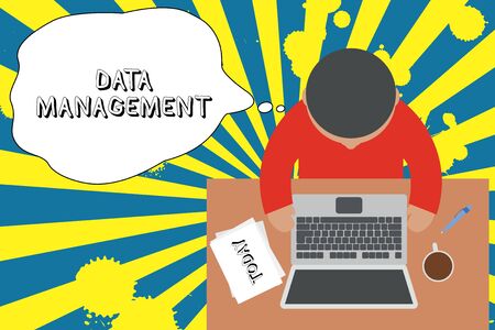 Writing note showing Data Management. Business concept for The practice of organizing and maintaining data processes Upper view young man sitting table laptop documents coffee cup penの写真素材