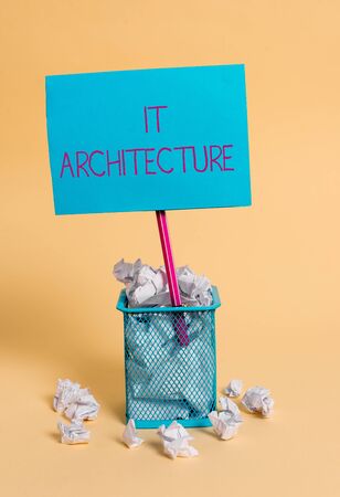 Word writing text It Architecture. Business photo showcasing Architecture is applied to the process of overall structure crumpled paper trash and stationary with note paper placed in the trash canの写真素材